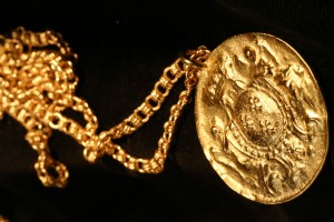old gold coin on chain