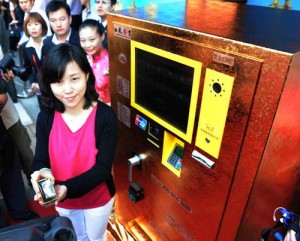 woman next to gold ATM