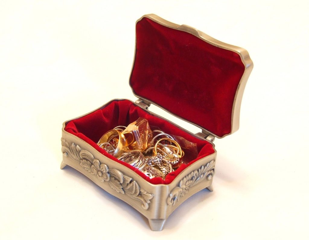 A small jewelry box full of gold items.