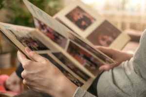 woman looks through photo book remembering loved one