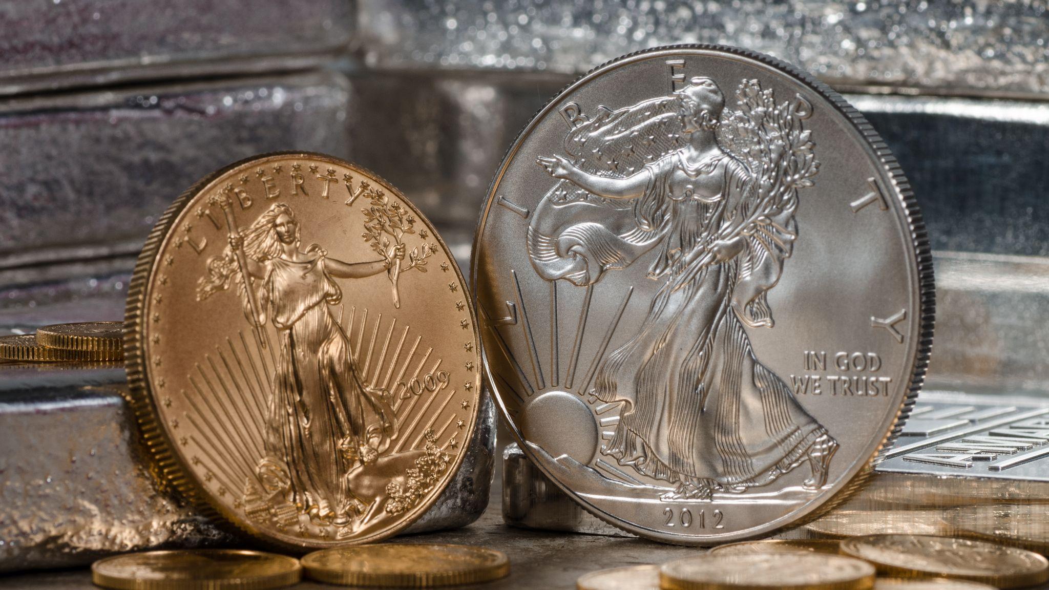 2012 gold and silver liberty coins with other coins in background.