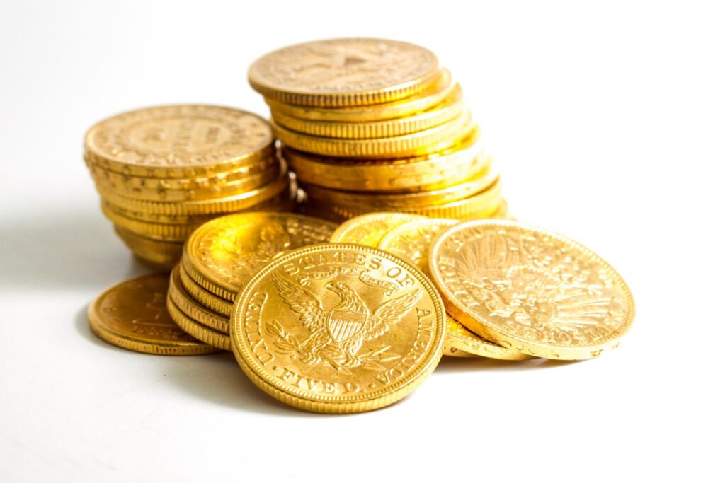 Stack of American gold coins on white background.
