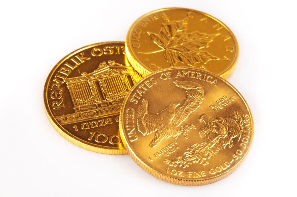 Three gold coins from different countries. 